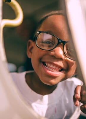 A smiling child wearing glasses