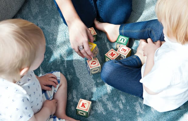 Children playing together with wooden blocks