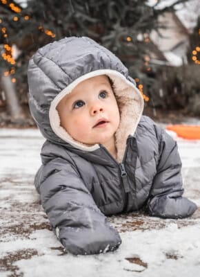 A child wearing a winter hat outdoors