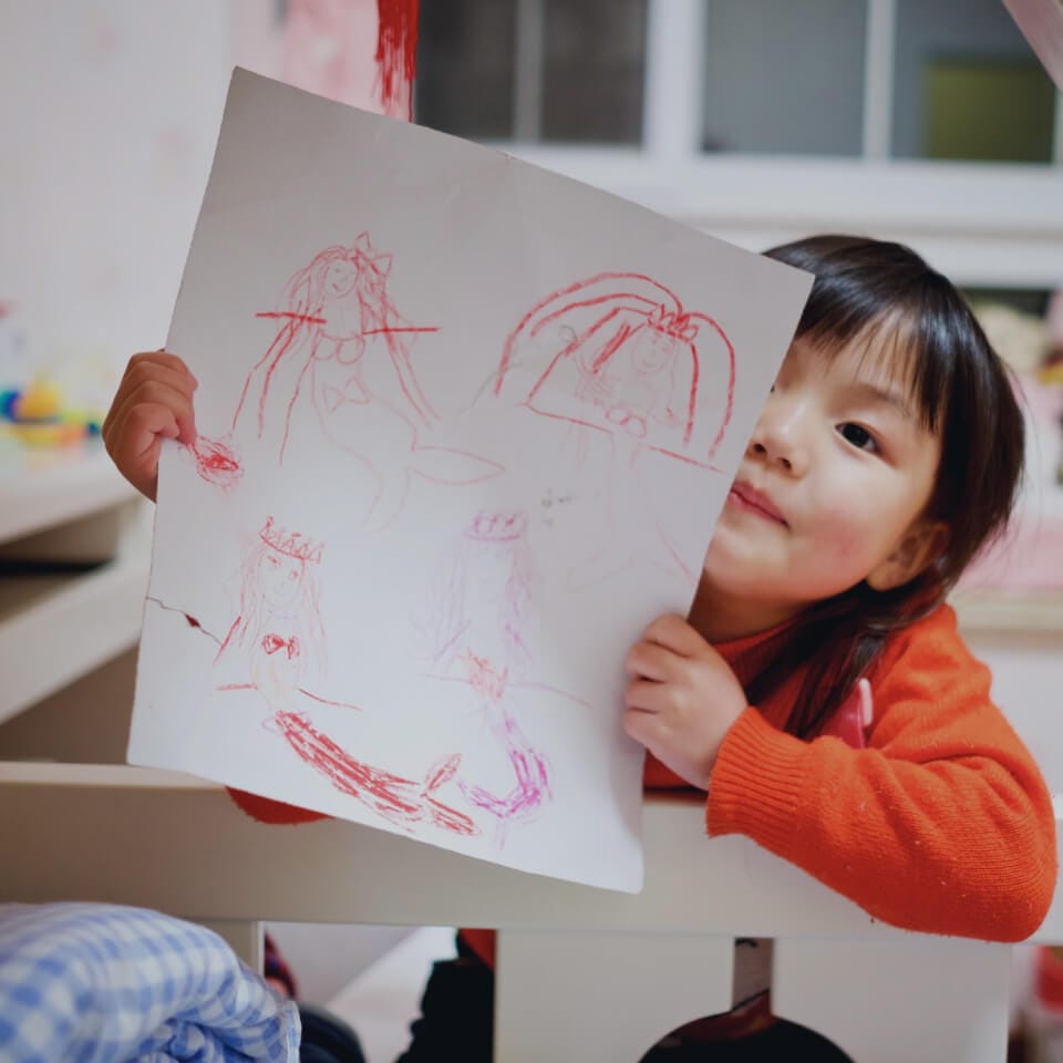 A child showing a drawing