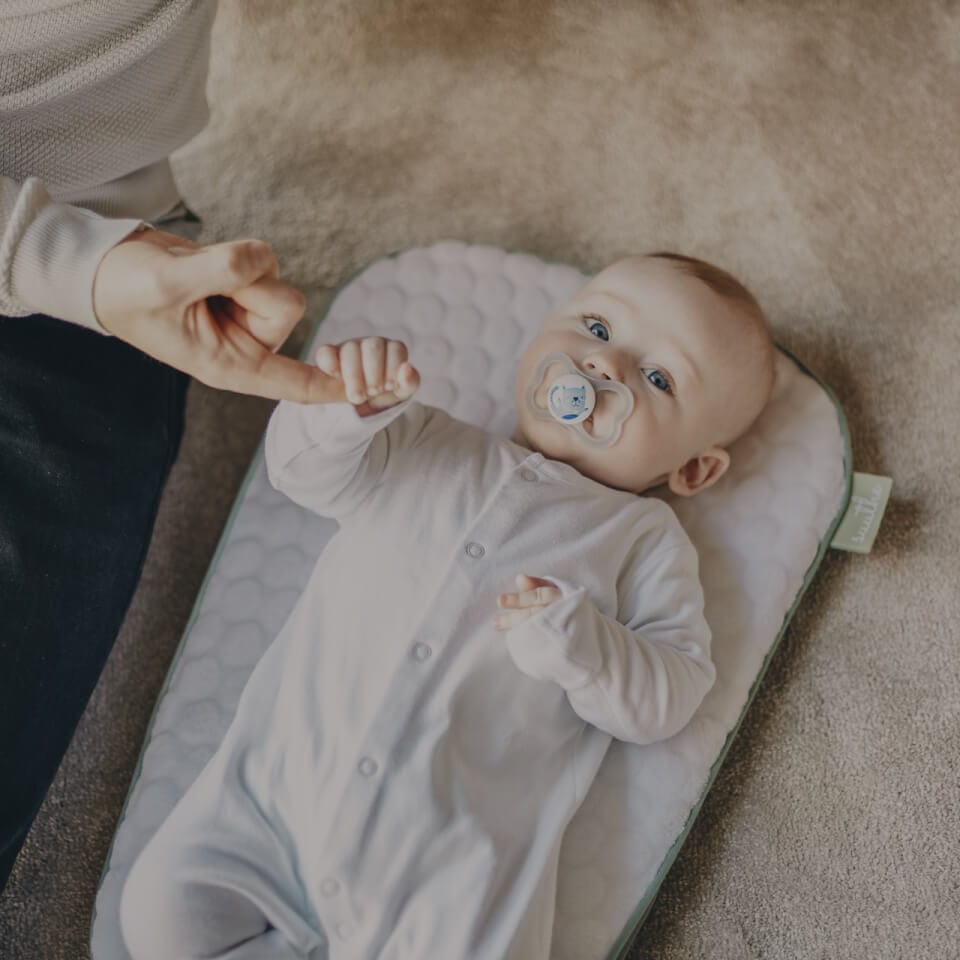 A baby lying on a soft blanket